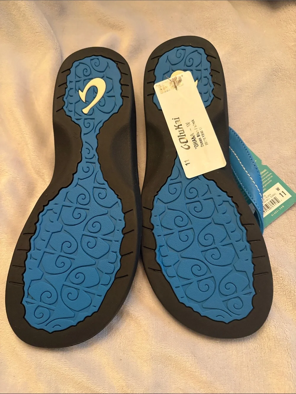 OluKai women’s Black Sandals with Bright Blue Straps